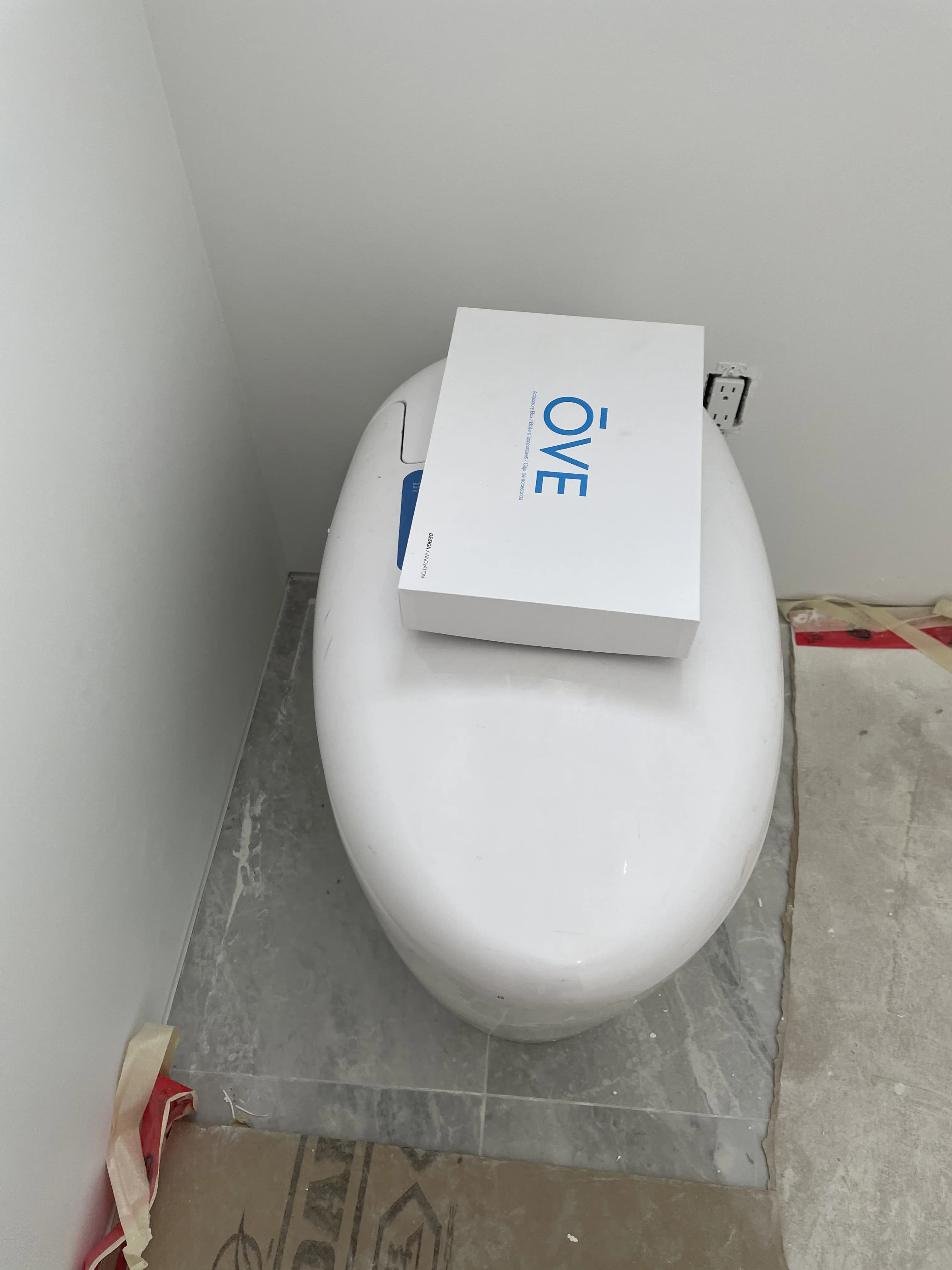 Wall-hung OVE toilet installation in Ajax on marble tile with floor protection during renovation