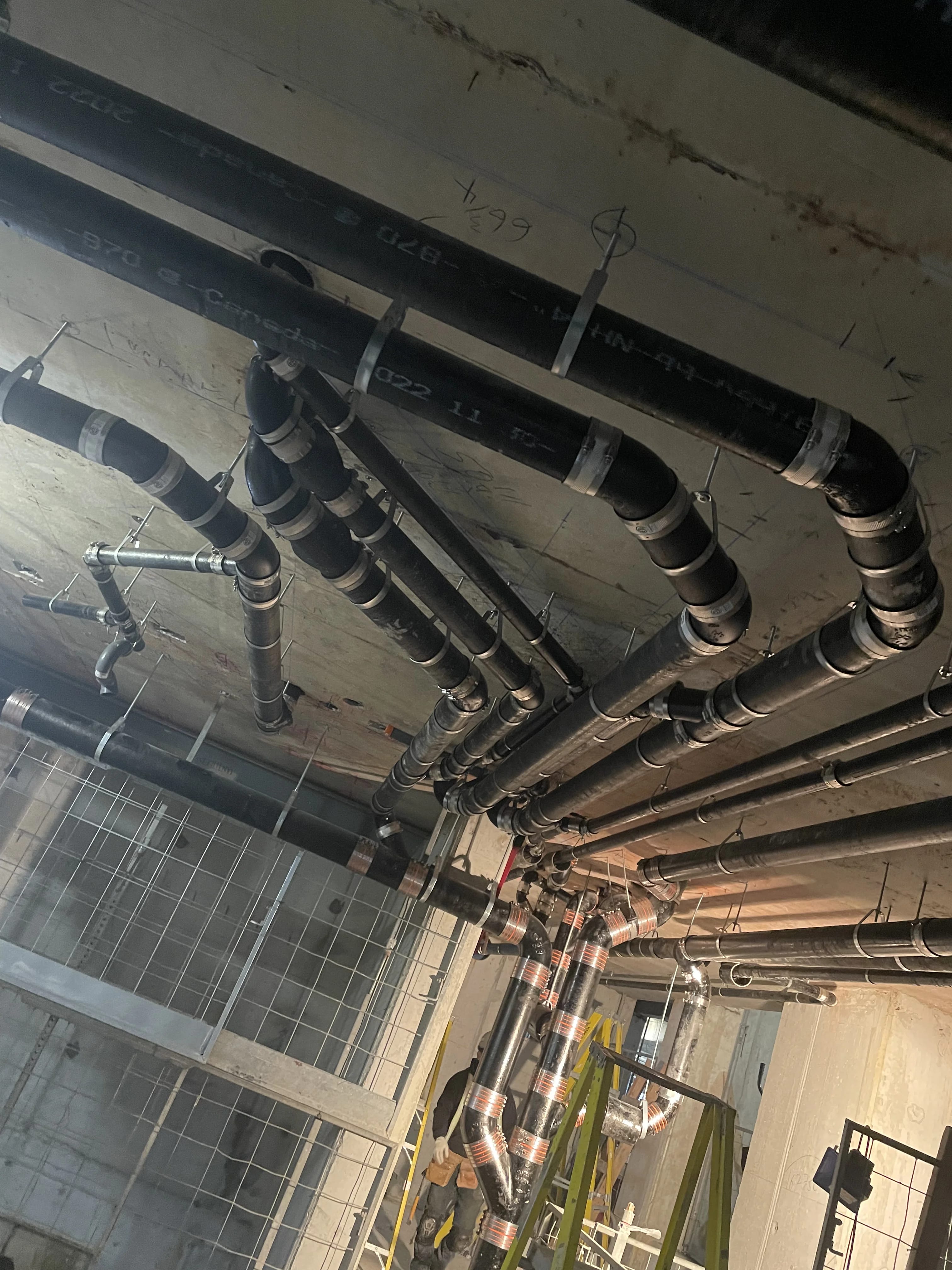 Commercial plumbing services ajax job showing ceiling drain mains during rough-in in a commercial build